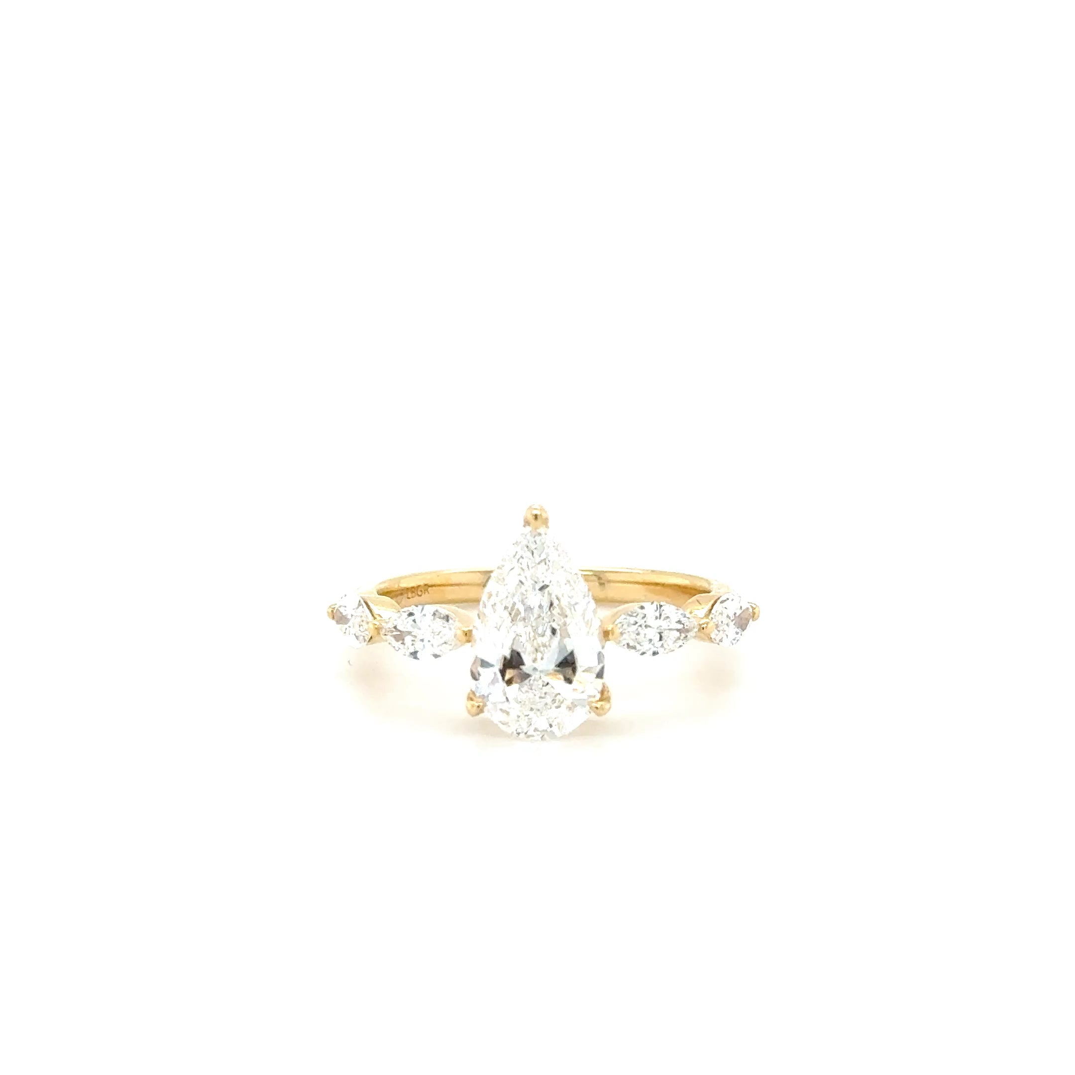 “Golden Elegance: Pear-Shaped Center with Sparkling Charm Diamonds – 2.19ct Lab-Grown”