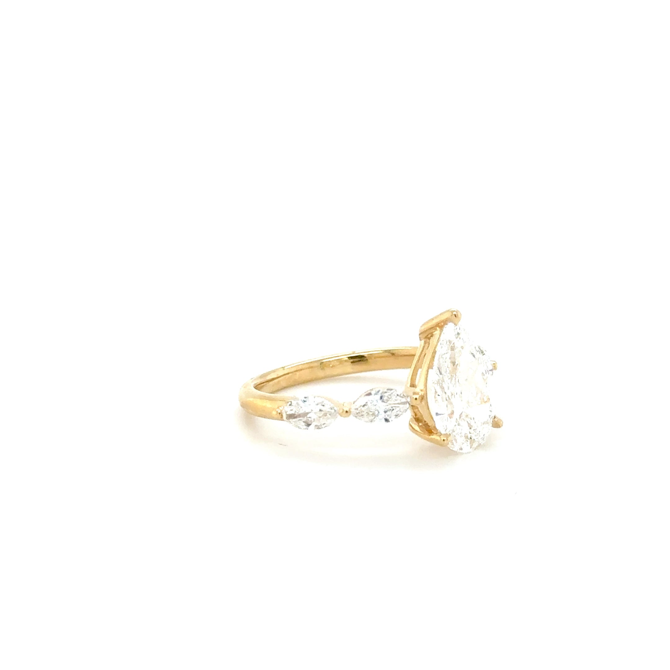 “Golden Elegance: Pear-Shaped Center with Sparkling Charm Diamonds – 2.19ct Lab-Grown”