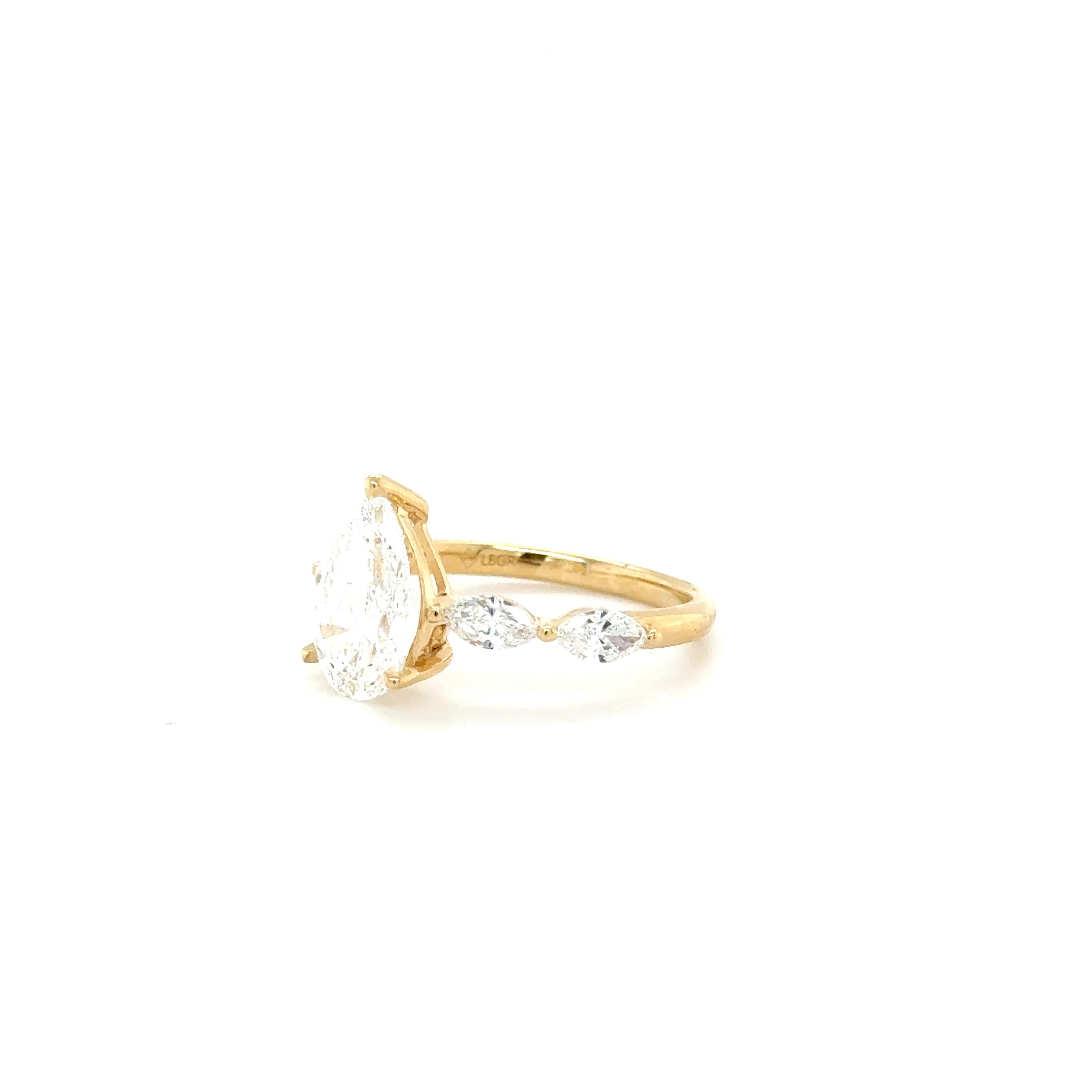 “Golden Elegance: Pear-Shaped Center with Sparkling Charm Diamonds – 2.19ct Lab-Grown”